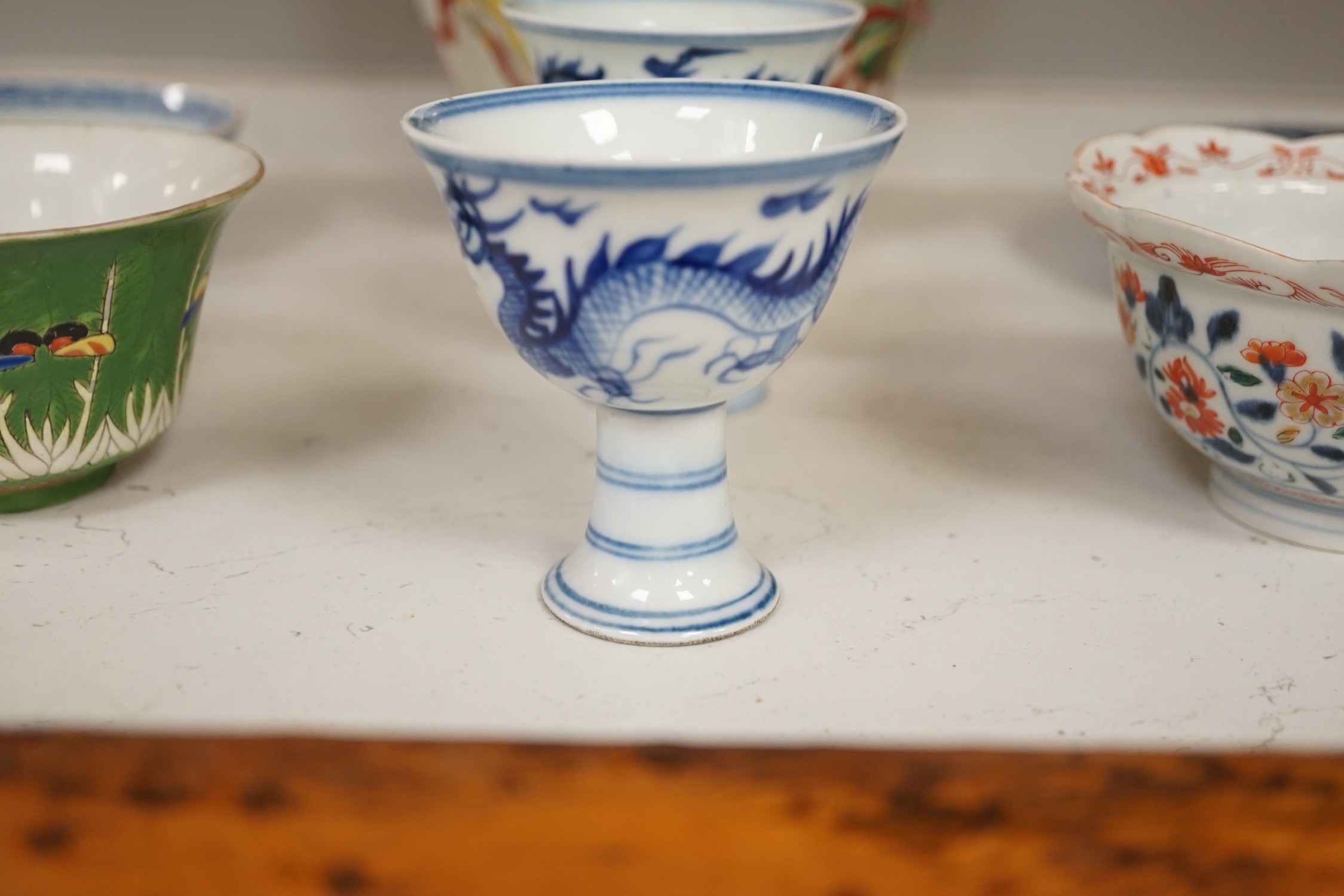 A Chinese wucai vase, two Imari bowls, a pair of Chinese blue and white dragon stem cups, Xuande marks, a Chinese blue and white dish, depicting a scholar on horseback, Xuande mark, a small green Chinese bowl, painted wi